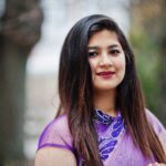 close up portrait indian hindu girl traditional violet saree posed street